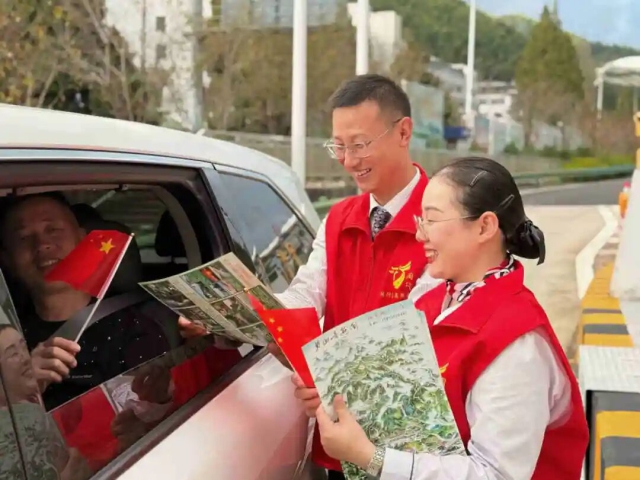黃山中心青年志愿者為過往司乘推介周邊景點并贈送小國旗.jpg
